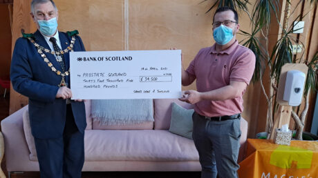 The Grand Master Mason presenting a cheque for £34,500 for Prostate Scotland to Brian Corr